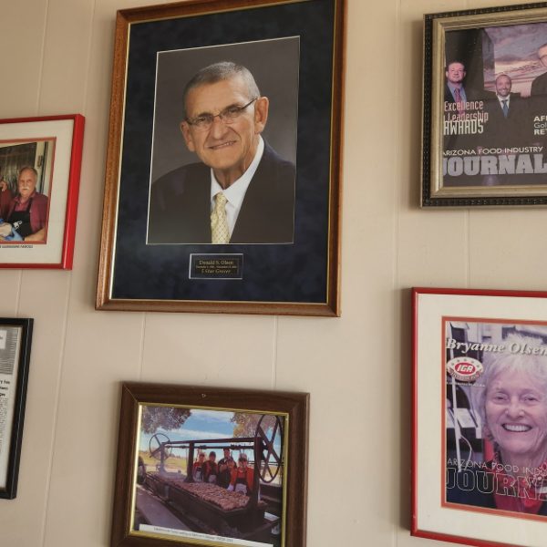 Framed portrait of Don Olsen and Arizona Food Industry Journal features on the wall inside the store